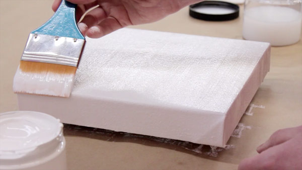 Priming a cotton duck canvas with acrylic gesso. Image courtesy opusartsupplies.com