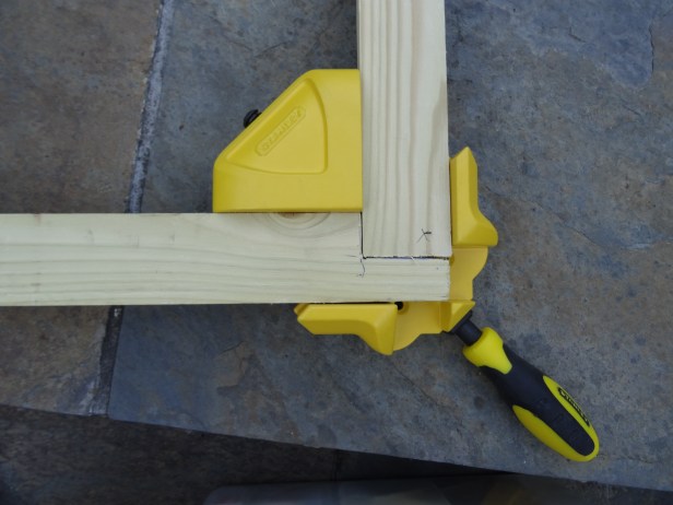 Making a canvas stretcher frame, aligning corner lap joint with frame clamps. Photo credit Kelise Franclemont.