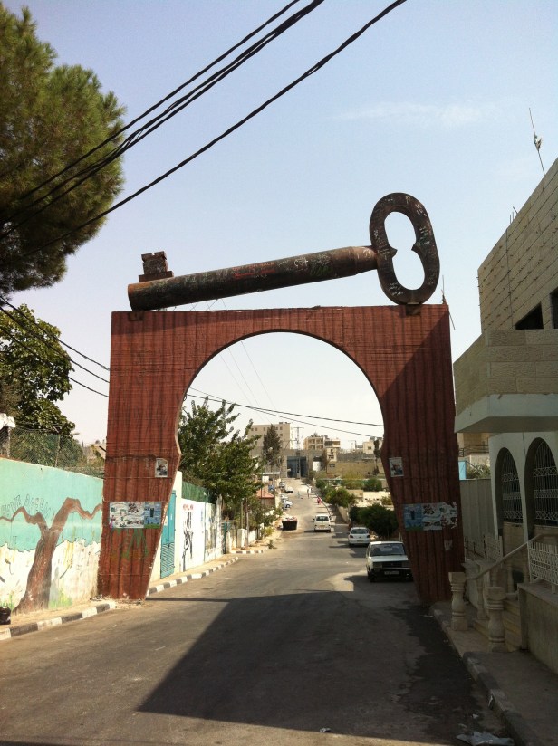 One of the many key sculptures, symbolising the refugees right to return someday to their homes. This one is adjacent to Aida refugee camp (you can see the wall at left of photo). Aida camp is situated near Bethlehem. Photo credit Tom Butler.