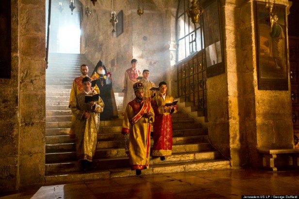 Armenian Apostolic priests descend the stairs to the Chapel of St Helena in the Church of the Holy Sepulchre. According to tradition, Queen Helena, mother to the Emperor Constantine, discovered remnants of the True Cross here in the 4th century C.E. (AD) during the construction of the original church, in 'Jerusalem 3-D', 2013, documentary film, 45 mins. Image courtesy National Geographic and The Huffington Post. Photo credit George Duffield.