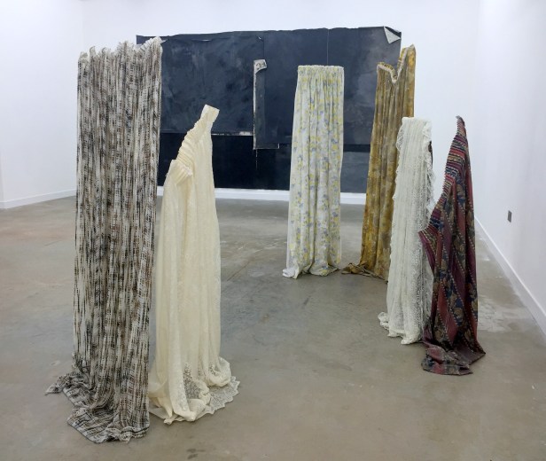 (background) Tess Williams, 'T.L.A.', ink, acrylic, oil stick, chalk on canvas, and (foreground) Kirsty Andrew, 'Behind Closed Doors', 2015, fabric and resin, in 'Young Gods' 2016 at Griffin Gallery, London. Photo credit Kelise Franclemont.